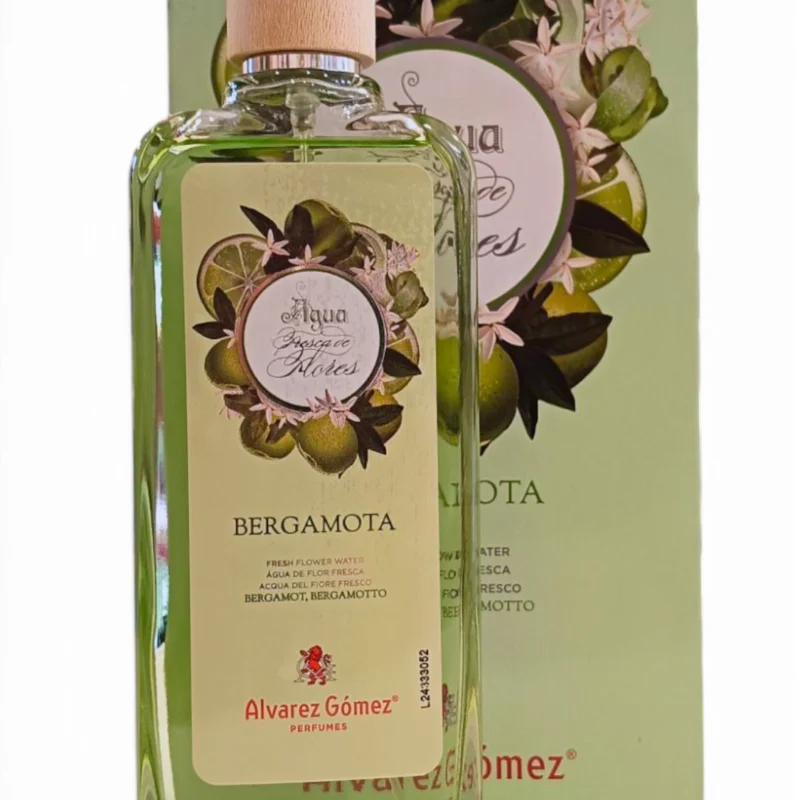Un frasco de 175 ml de Álvarez Gómez Bergamota EDT edición Lata con tapón de madera se encuentra delante de su caja a juego con motivos florales, ambos con diseños florales y detalles de la marca.