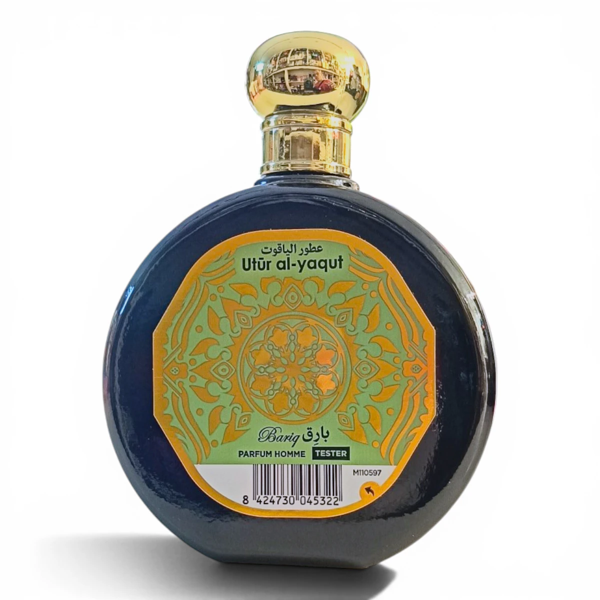 Frasco redondo de perfume negro con tapón dorado y etiqueta ornamentada en amarillo y naranja en la que se lee Utur al-yaqut y Barij junto con un texto en árabe. La etiqueta también indica Parfum Homme Tester y muestra un código de barras.