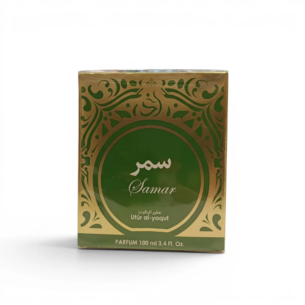 Caja de perfume cuadrada, verde y dorada, etiquetada como Samar, con escritura árabe, motivos decorativos y el texto Utûr al-yaqût PARFUM 100 ml 3.4 FL. Oz. en el anverso.