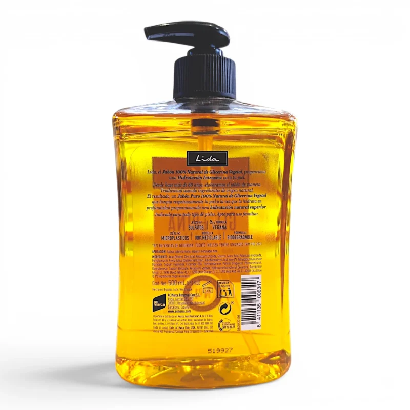 Un frasco de plástico transparente con dosificador de «Jabón 100 % natural de glicerina vegetal Lida» de 500 ml, que contiene jabón líquido amarillo, un dosificador negro y una etiqueta trasera en la que figuran la información del producto, los símbolos de reciclaje y el código de barras sobre un fondo blanco.